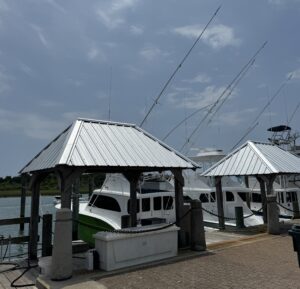 Sport fishing boats docked at a sidewalk pier.